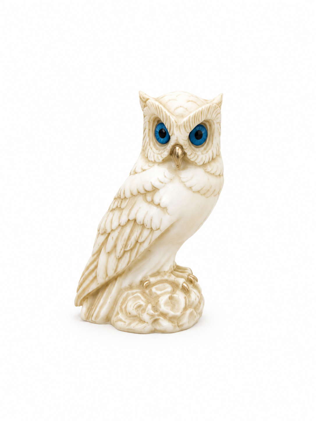 Owl observes statue sitting on a tree branch — image 3