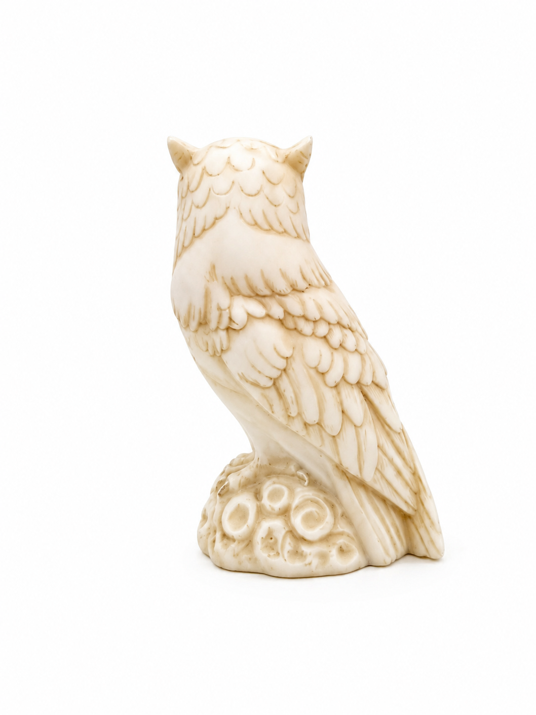 Owl observes statue sitting on a tree branch — image 4