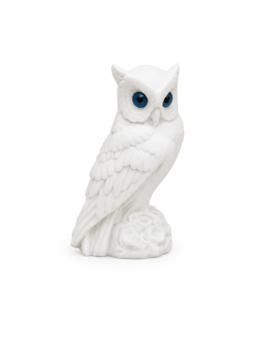 Owl observes statue sitting on a tree branch