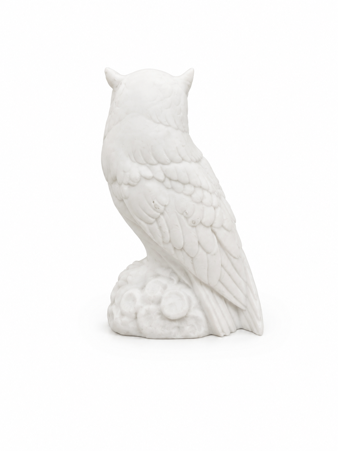 Owl observes statue sitting on a tree branch — image 2