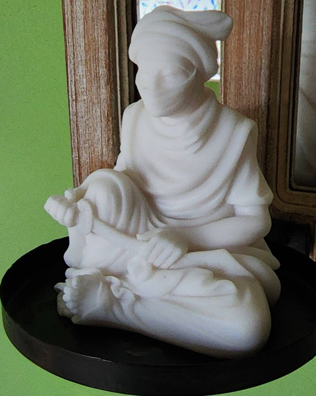Arab man statue holding knife sitting down — image 2