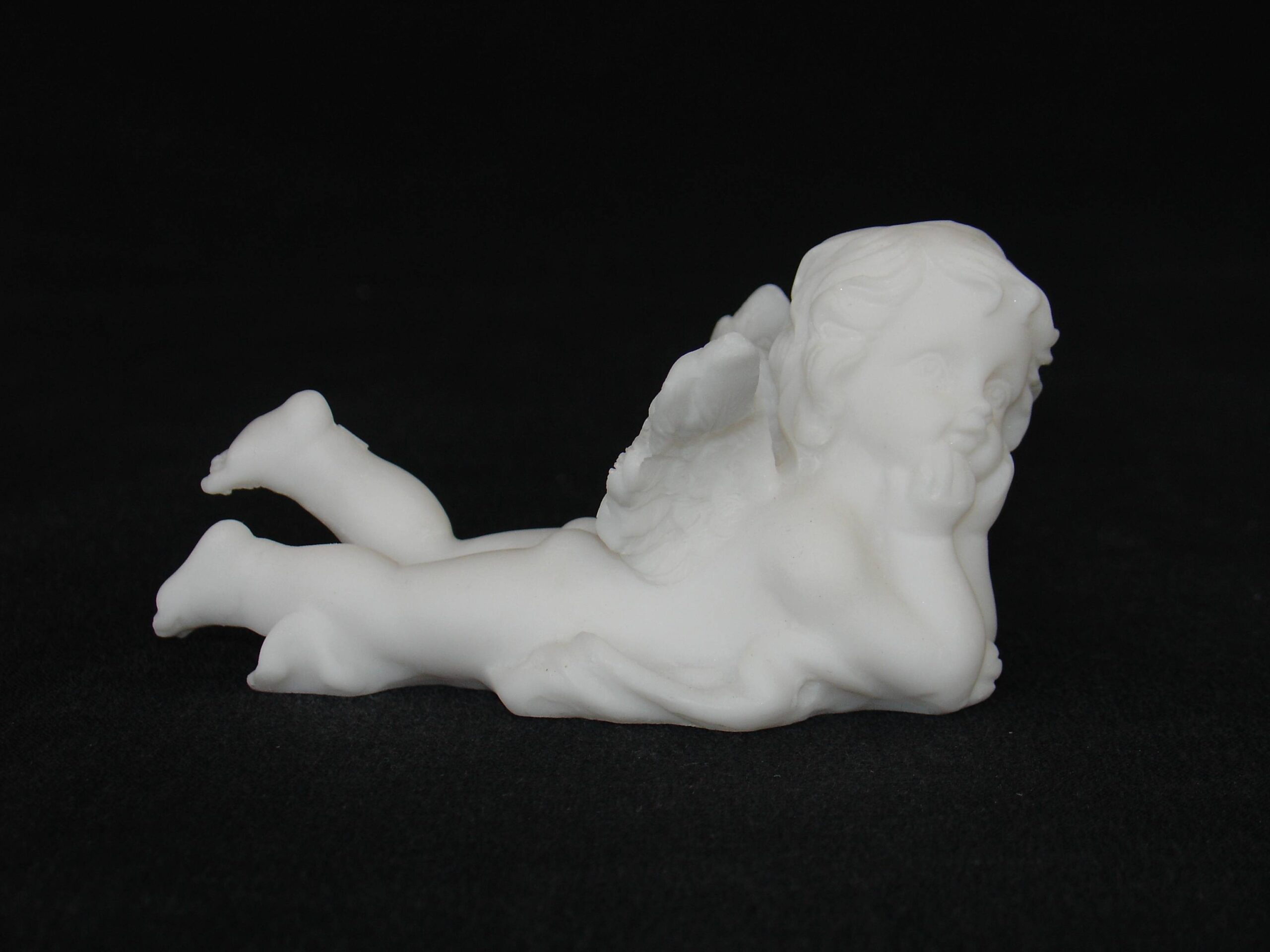 Lying angel holds his head statue — image 2