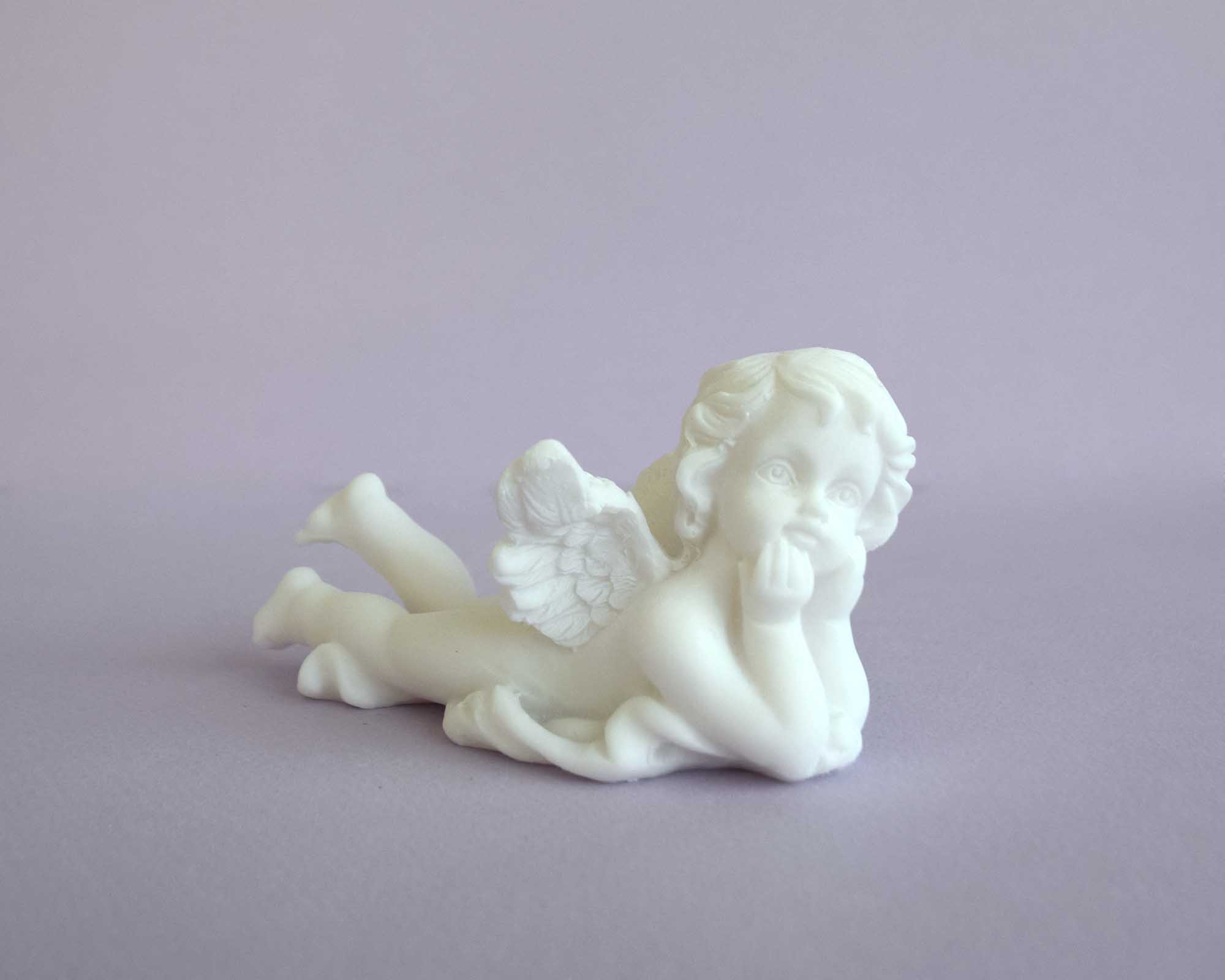 Lying angel holds his head statue — image 4