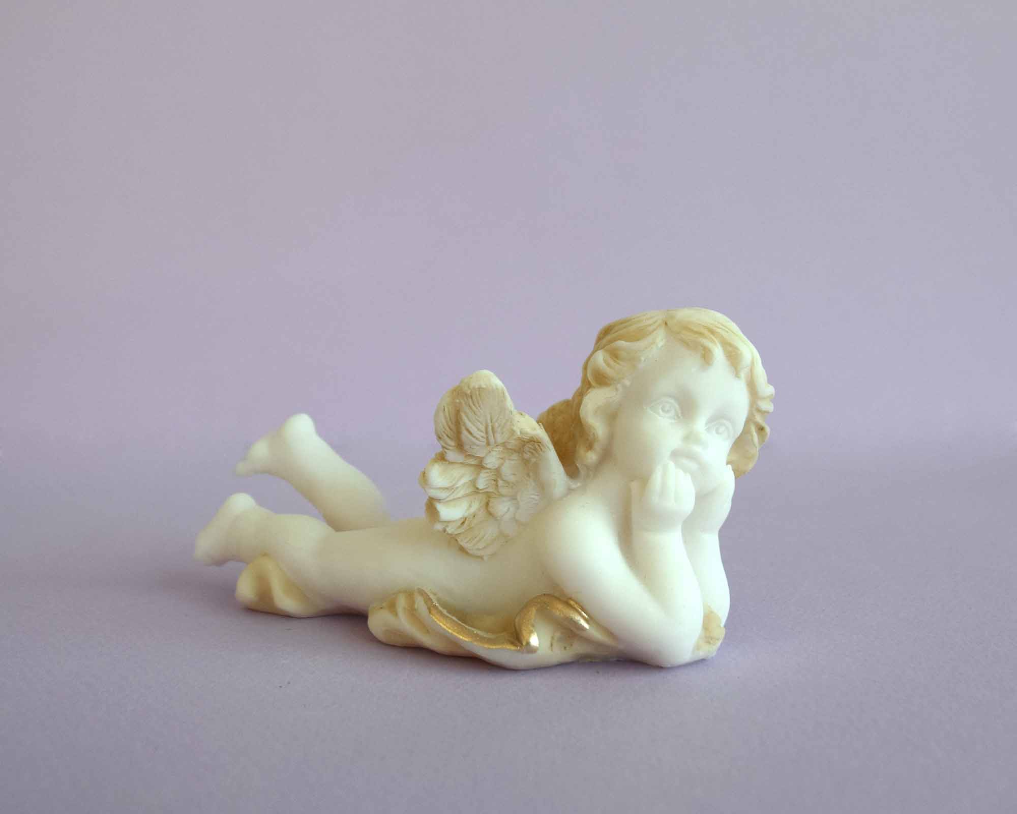 Lying angel holds his head statue — image 3