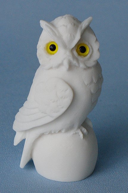 Owl sitting on a sphere statue — image 4