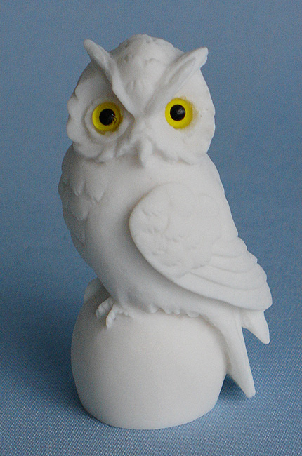 Owl sitting on a sphere statue — image 3