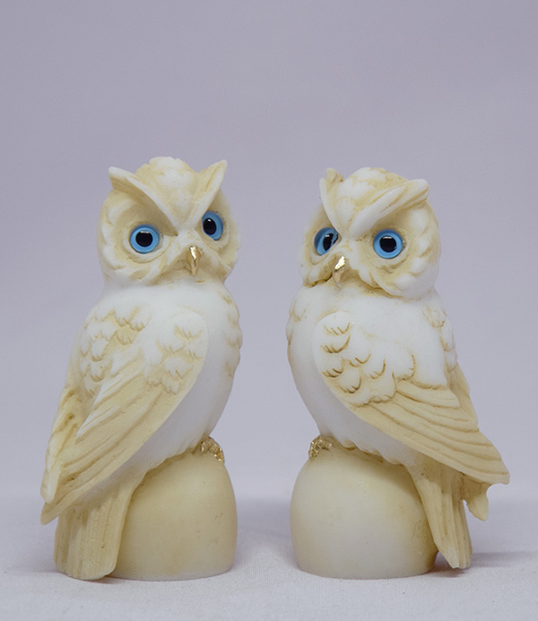 Owl sitting on a sphere statue — image 2